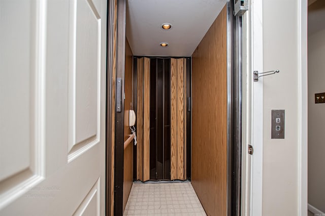 bathroom with tile patterned flooring and elevator