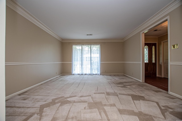 unfurnished room with crown molding and light colored carpet