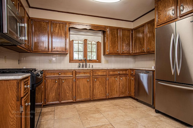 kitchen featuring backsplash, light tile patterned floors, stainless steel appliances, and sink