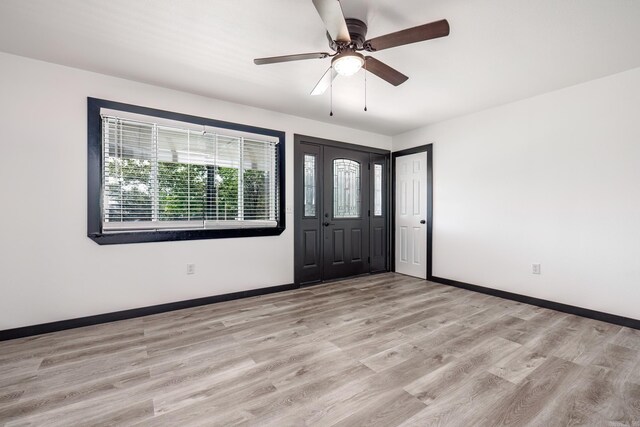 foyer with light hardwood / wood-style flooring and ceiling fan