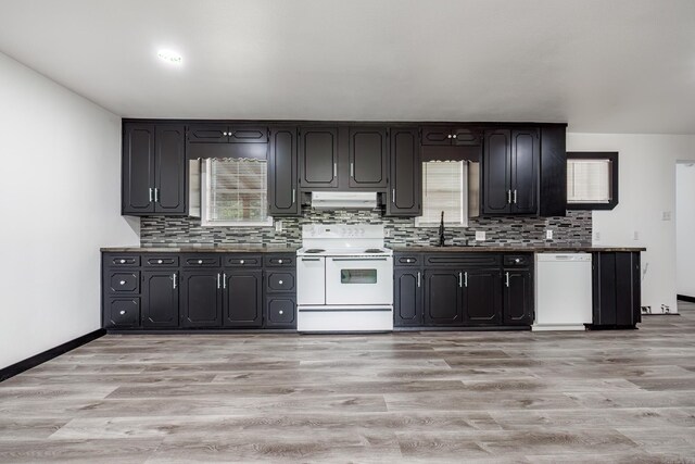 kitchen featuring light wood-type flooring, white appliances, and tasteful backsplash