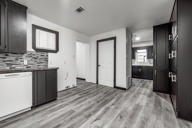 kitchen with dishwasher, decorative backsplash, and light hardwood / wood-style floors