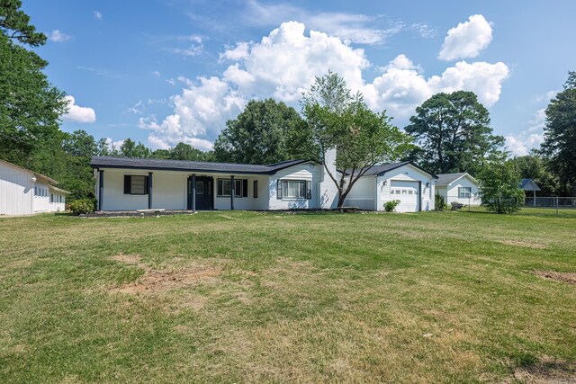 view of front of property featuring a garage and a front yard