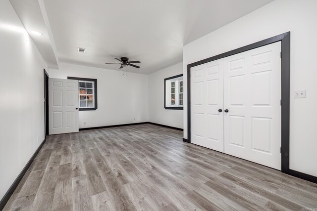 unfurnished bedroom with ceiling fan and light hardwood / wood-style floors