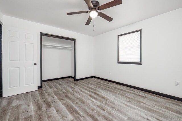 unfurnished bedroom featuring light hardwood / wood-style flooring, ceiling fan, and a closet