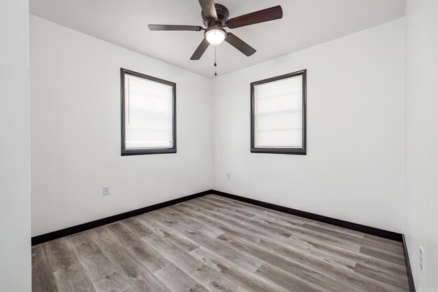 empty room featuring light hardwood / wood-style flooring and ceiling fan