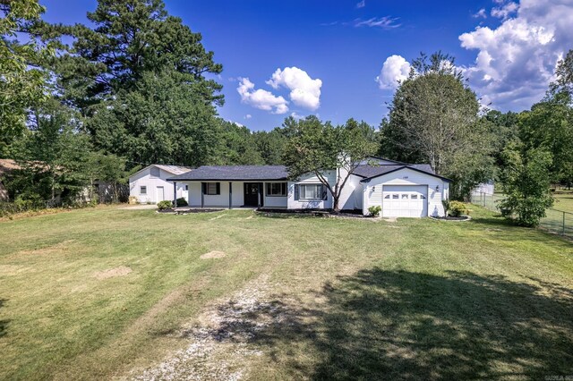 ranch-style home with a front yard and a garage