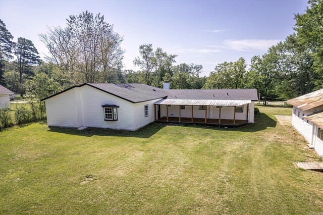 back of property featuring a yard