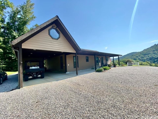 exterior space with a carport and a mountain view