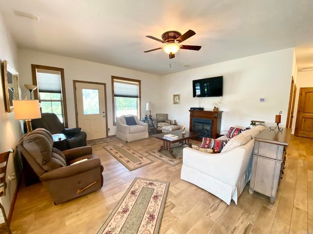 living room with light hardwood / wood-style flooring and ceiling fan