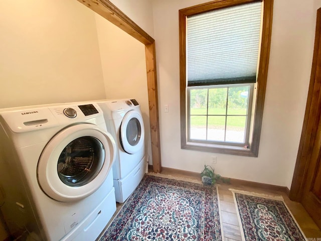 laundry room with tile patterned floors and washer and dryer