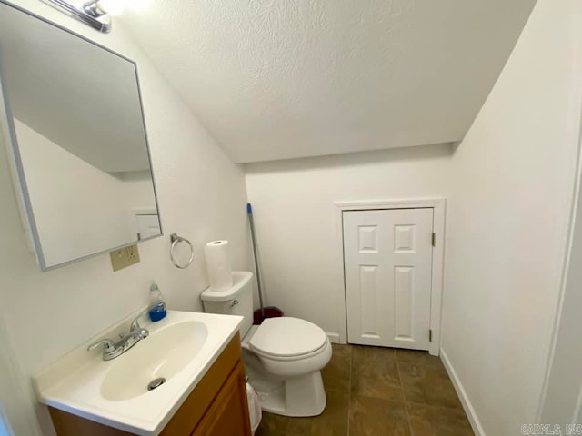 bathroom with tile patterned flooring, vanity, and toilet