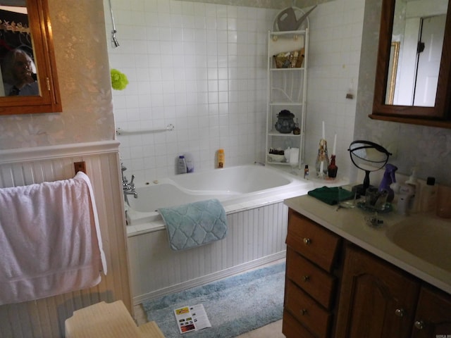 bathroom featuring vanity and a bath