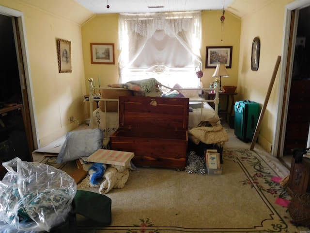 sitting room featuring carpet and vaulted ceiling