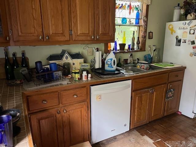 kitchen featuring dark wood-type flooring, sink, and white appliances