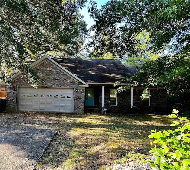 ranch-style home with a front yard and a garage