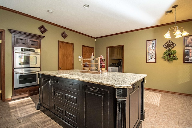 kitchen with a notable chandelier, crown molding, visible vents, double oven, and dark cabinets