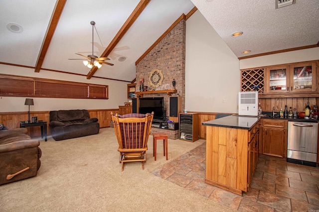 interior space with a fireplace, carpet, ceiling fan, and lofted ceiling with beams