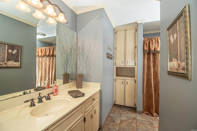 bathroom featuring a textured ceiling, ornamental molding, stone finish floor, and vanity