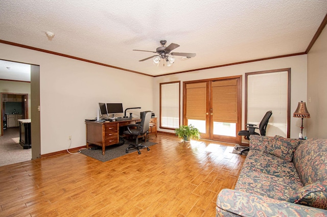 office area with light wood finished floors, crown molding, baseboards, and a textured ceiling