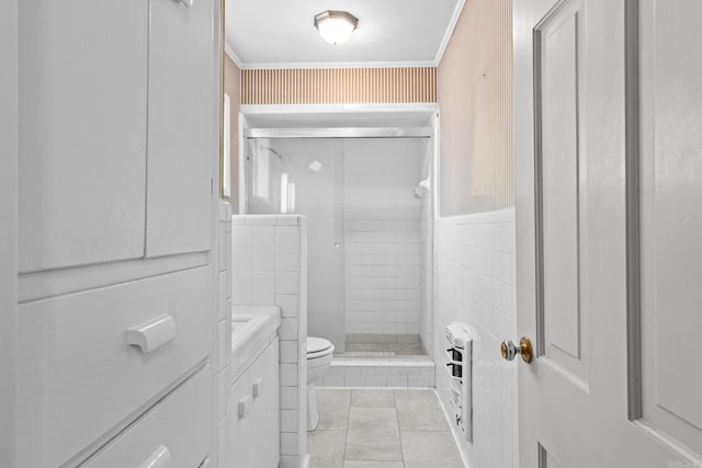 bathroom featuring toilet, crown molding, an enclosed shower, tile patterned floors, and tile walls