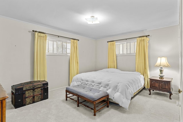 bedroom with multiple windows, crown molding, and carpet