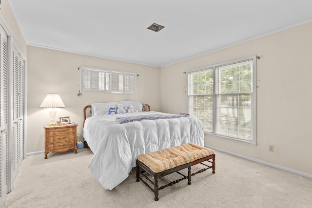 carpeted bedroom featuring crown molding