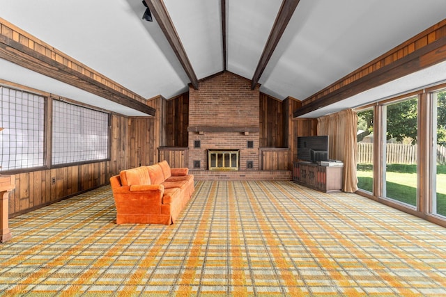 unfurnished living room with a fireplace, lofted ceiling with beams, and wooden walls