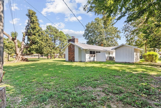 view of yard with a storage shed and cooling unit