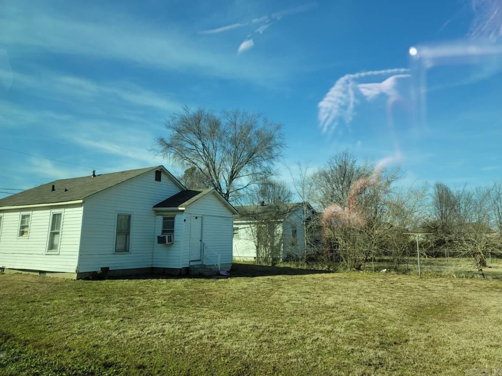 view of home's exterior with cooling unit and a yard