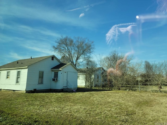 view of home's exterior with cooling unit and a yard