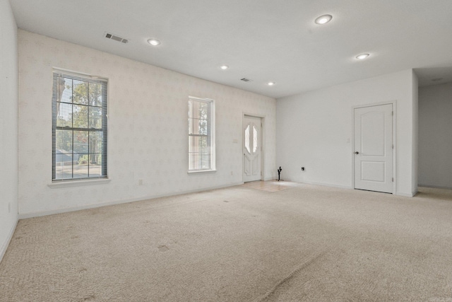 empty room featuring recessed lighting, carpet, visible vents, and baseboards