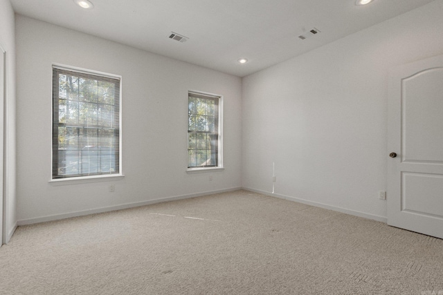 unfurnished room featuring visible vents, recessed lighting, and light colored carpet