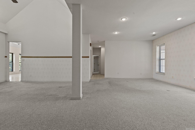 spare room with light carpet, lofted ceiling, and ceiling fan