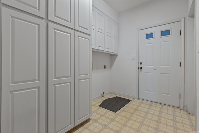 laundry area featuring cabinet space, hookup for an electric dryer, and light floors