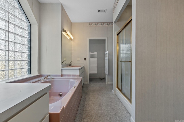 bathroom with a shower stall, a jetted tub, vanity, and visible vents