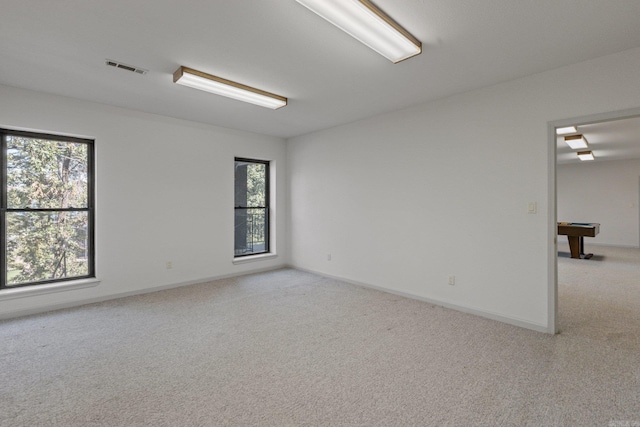 carpeted empty room featuring visible vents, baseboards, and pool table