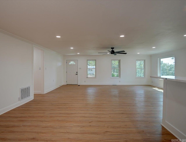 unfurnished living room with ceiling fan, crown molding, and light hardwood / wood-style flooring