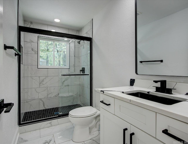 bathroom featuring vanity, an enclosed shower, and toilet