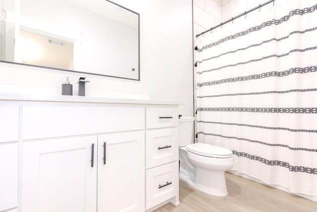 211 Woodland Shores Cir, Clinton, AR 72031 - bathroom featuring vanity, toilet, a shower with shower curtain, visible vents, and wood finished floors