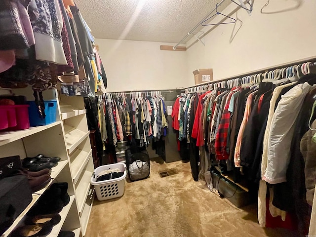 walk in closet featuring carpet floors