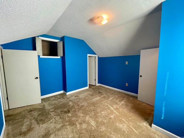 bonus room featuring a textured ceiling, carpet, and vaulted ceiling