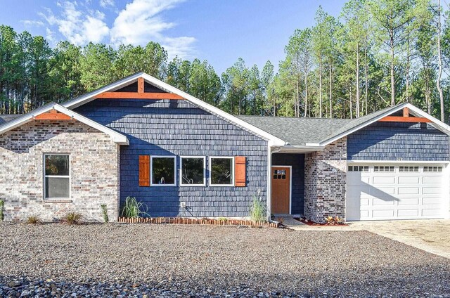 ranch-style house featuring cooling unit and a garage