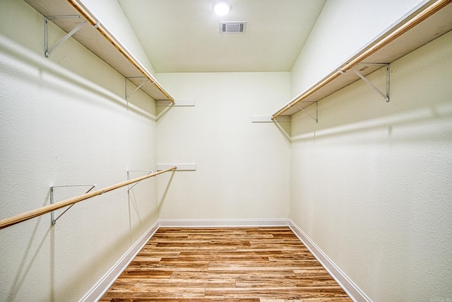 spacious closet featuring light wood-style floors and visible vents