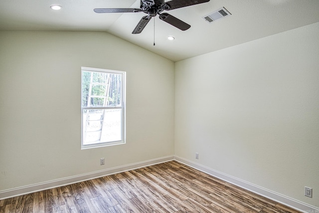 spare room featuring ceiling fan, hardwood / wood-style flooring, and vaulted ceiling