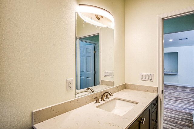 bathroom with hardwood / wood-style flooring and vanity