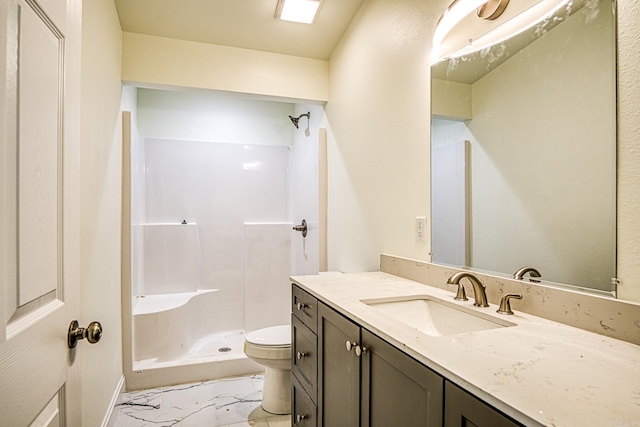 bathroom with marble finish floor, vanity, a shower stall, and toilet