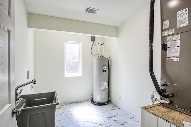 utility room with water heater, visible vents, and heating unit