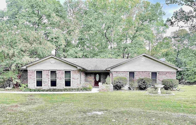 ranch-style house with a front yard, brick siding, and roof with shingles