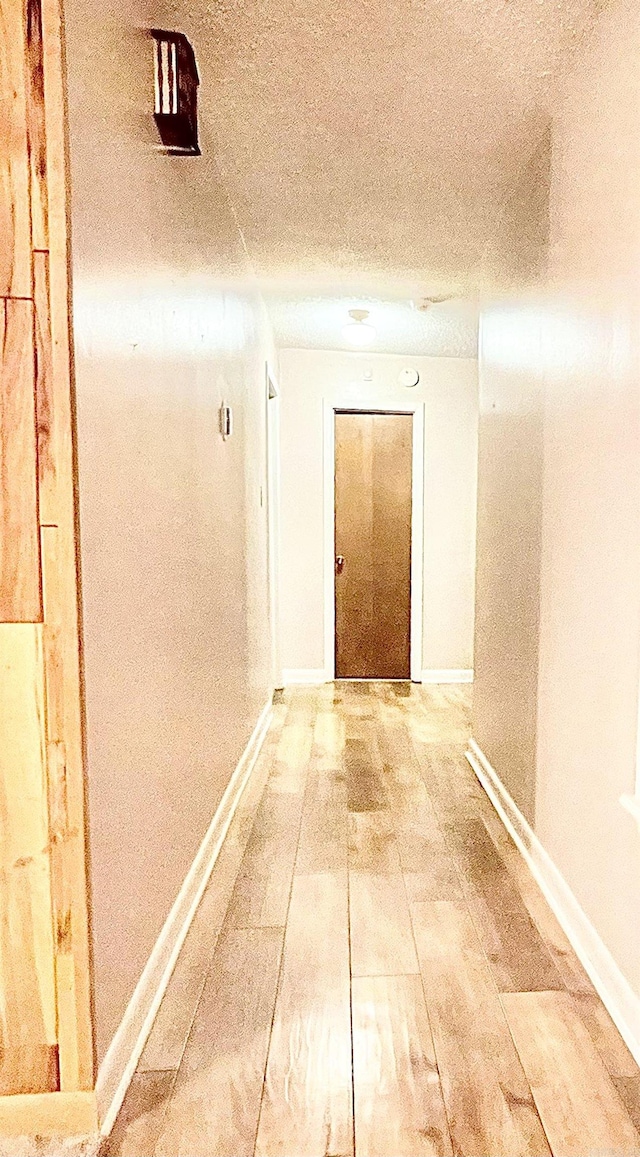 hallway featuring a textured ceiling